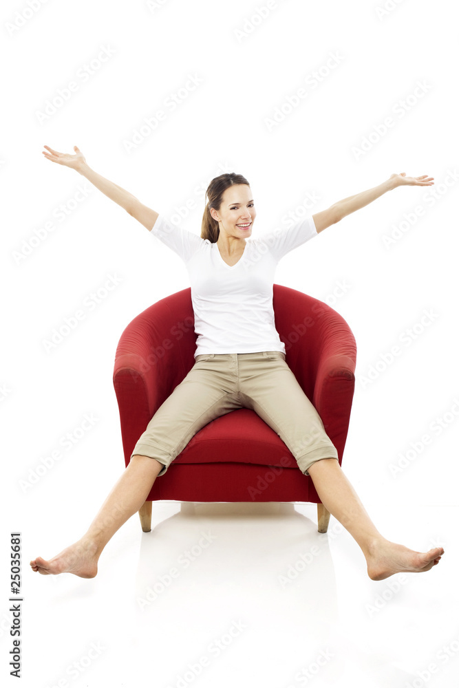 Young woman sitting on a chair on white background studio