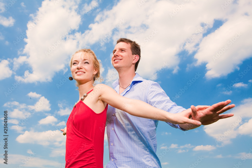 Young love Couple smiling under blue sky Young love Couple smiling under blue sky