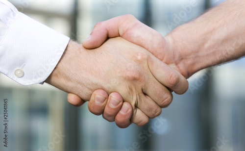 Handshake between office workers