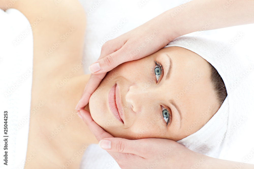 Young positive woman enjoying a facial massage Young positive woman enjoying a facial massage