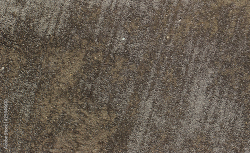 brown gray gravel ground surface seen from top with tracks from