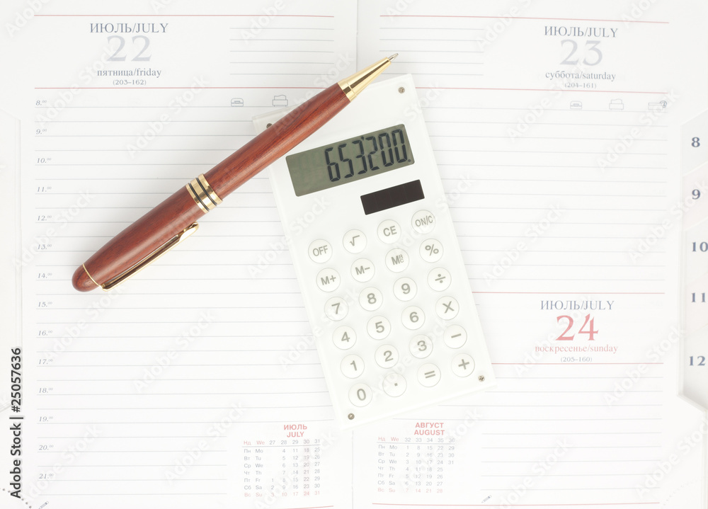 Pen and white calculator on the organizer, top view Pen and white calculator on the organizer, top view