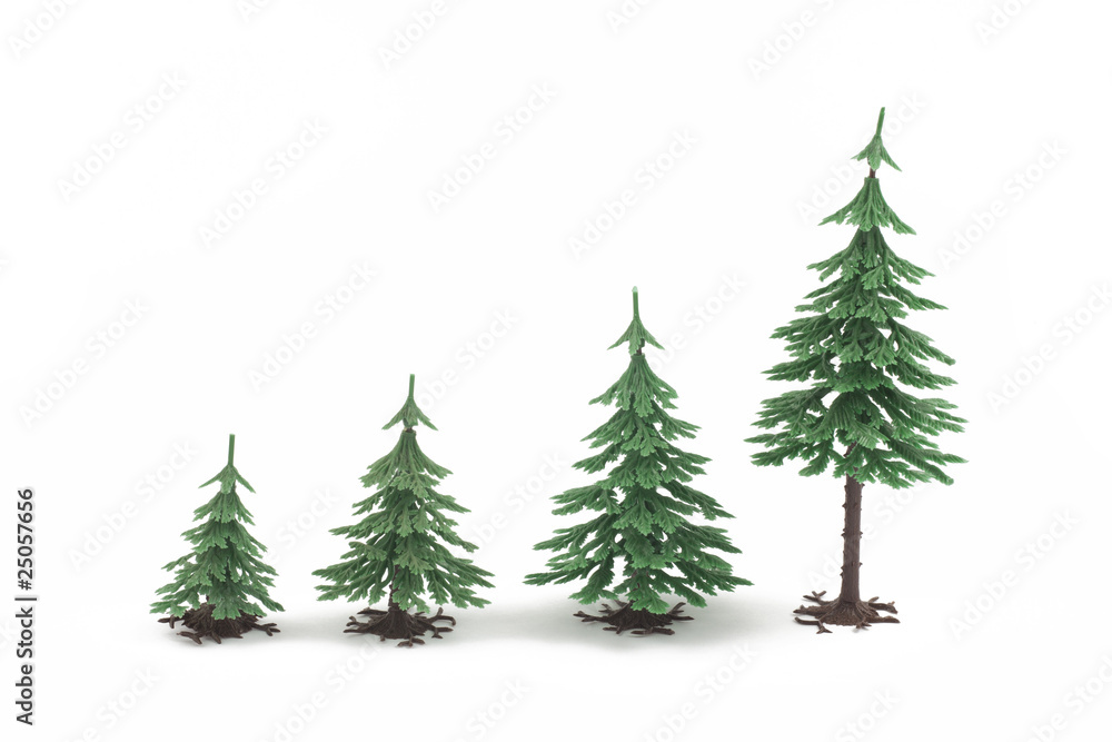 Four plastic fur-trees on white background