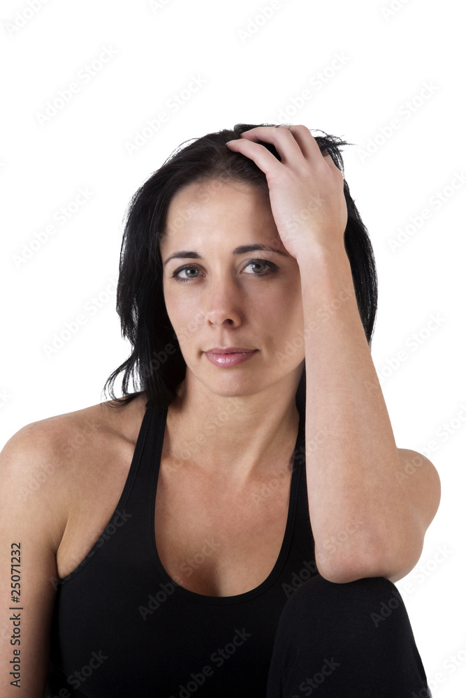 Woman in exercise clothes, sitting on the floor Woman in exercise clothes, sitting on the floor