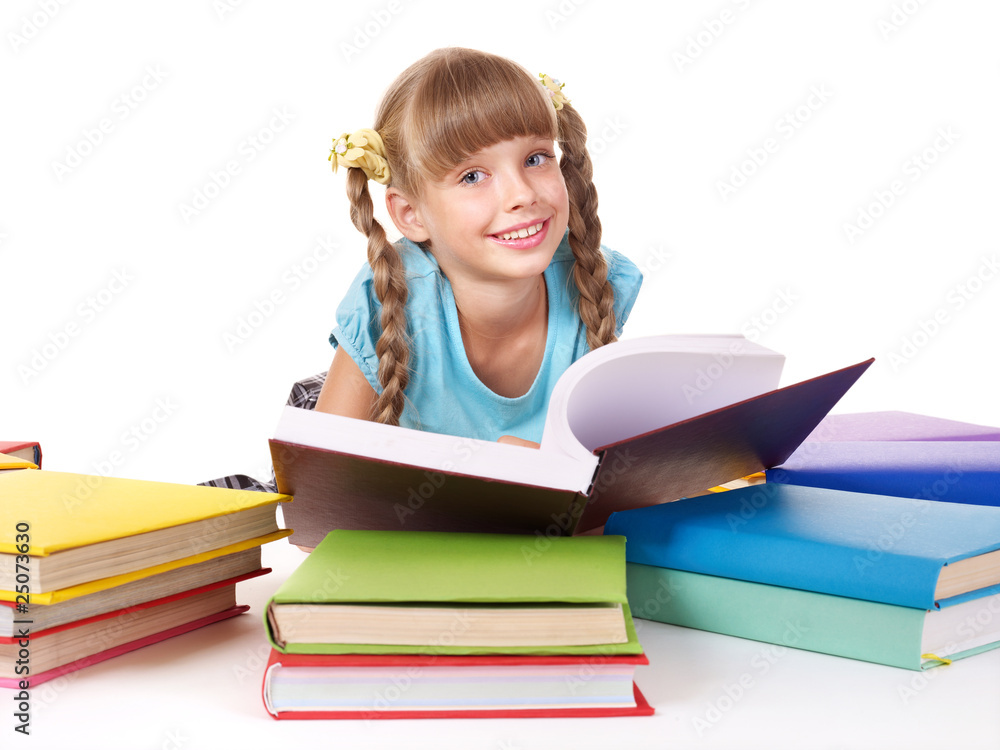 Child with pile of books reading on floor. Child with pile of books reading on floor.