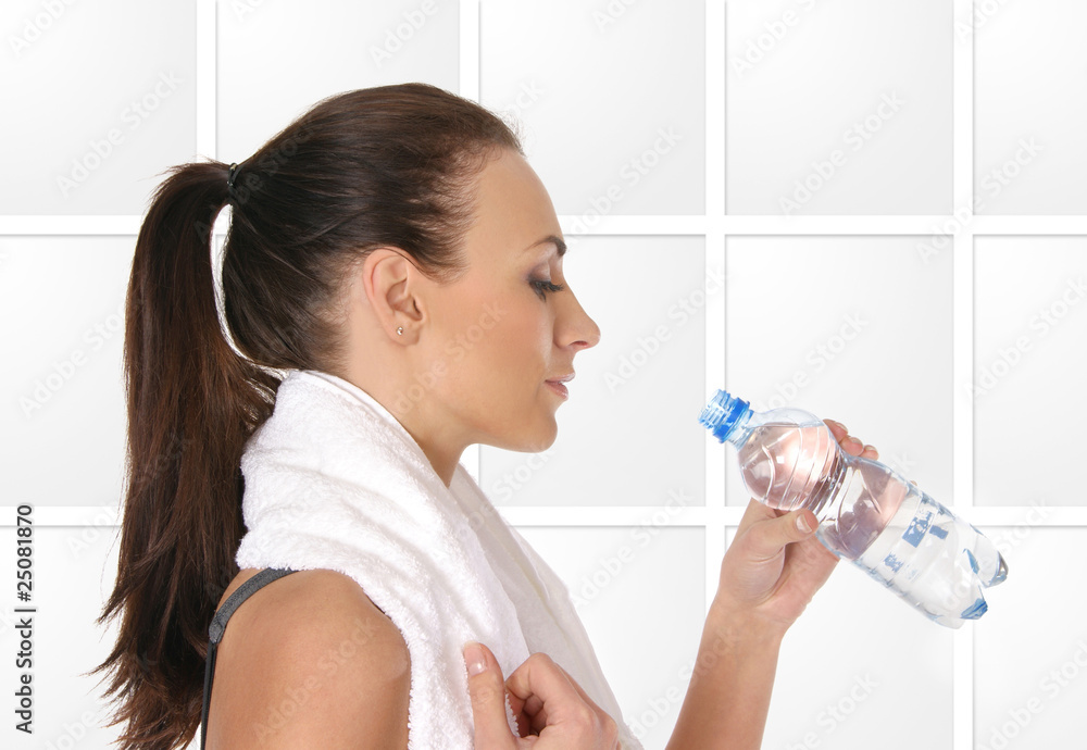 Young attractive female sportsman drinking water Young attractive female sportsman drinking water