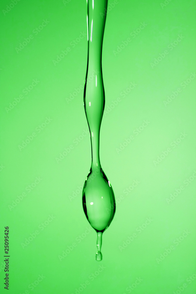 falling transparent drop of water in blue background falling transparent drop of water in blue background