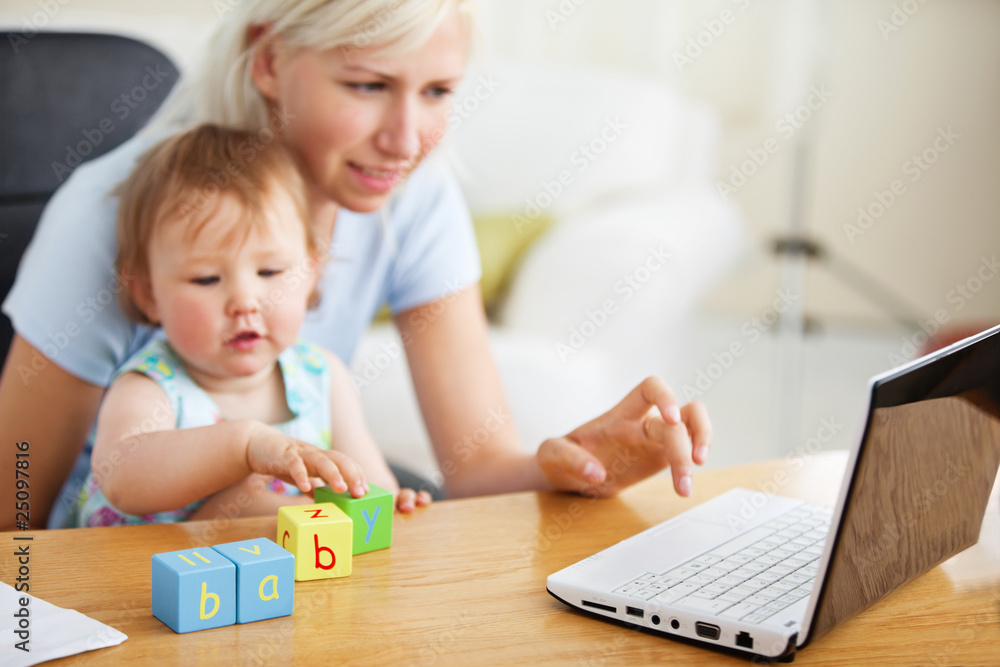 Positive family using laptop and playing with toys Positive family using laptop and playing with toys