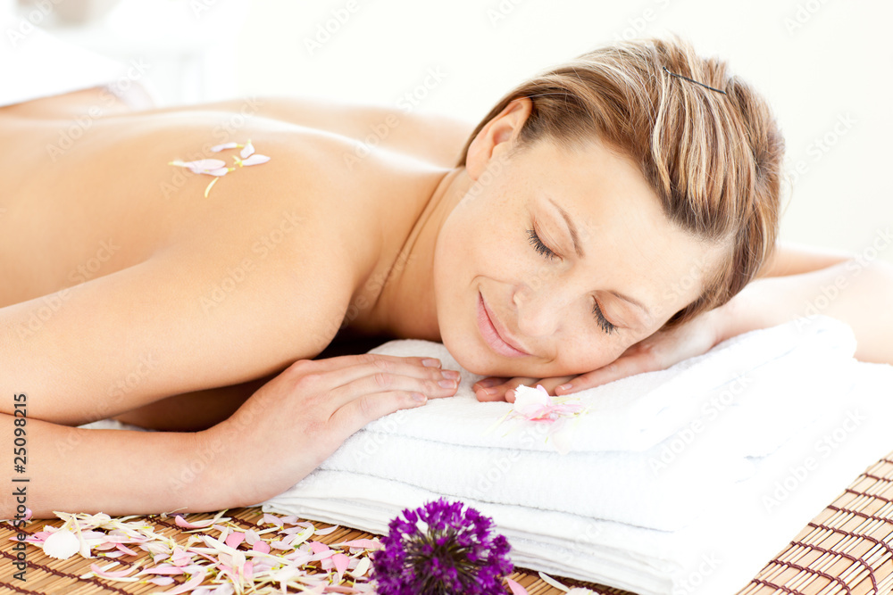 Beautiful relaxed woman lying on a massage table Beautiful relaxed woman lying on a massage table