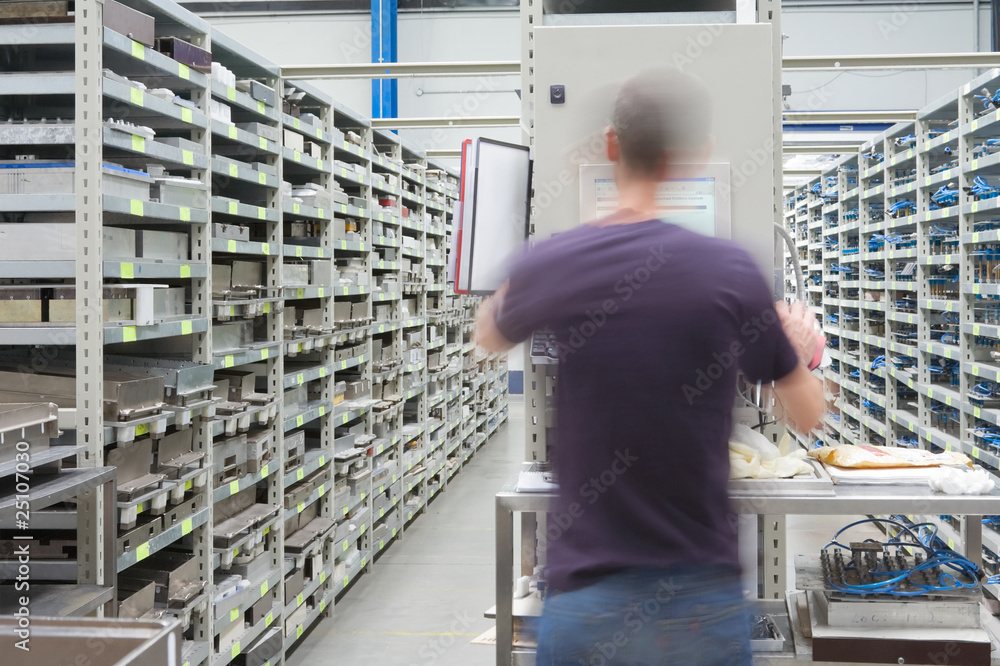 shelves with spar parts and technician in motion shelves with spar parts and technician in motion