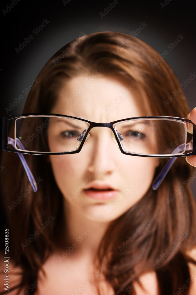 Fototapeta premium Woman looking at glasses