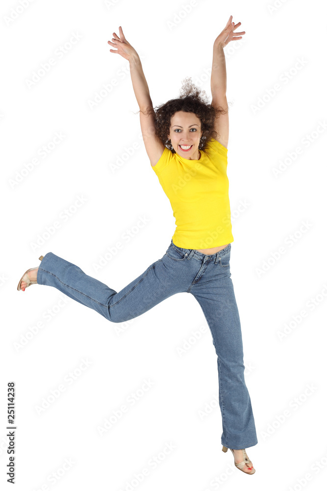young attractive woman in yellow shirt and jeans jumping young attractive woman in yellow shirt and jeans jumping