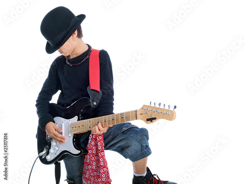 child rock star playing e guitar isolated on white background