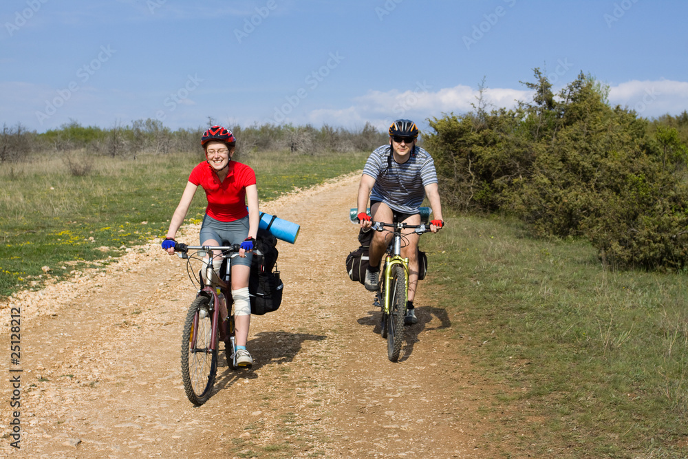 Couple of cyclists have a bicycle travel.