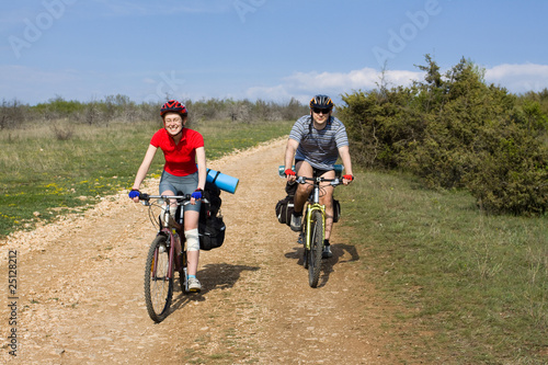 Couple of cyclists have a bicycle travel.