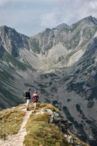A pair of tourists admire the scenery in the Tatra Mountains