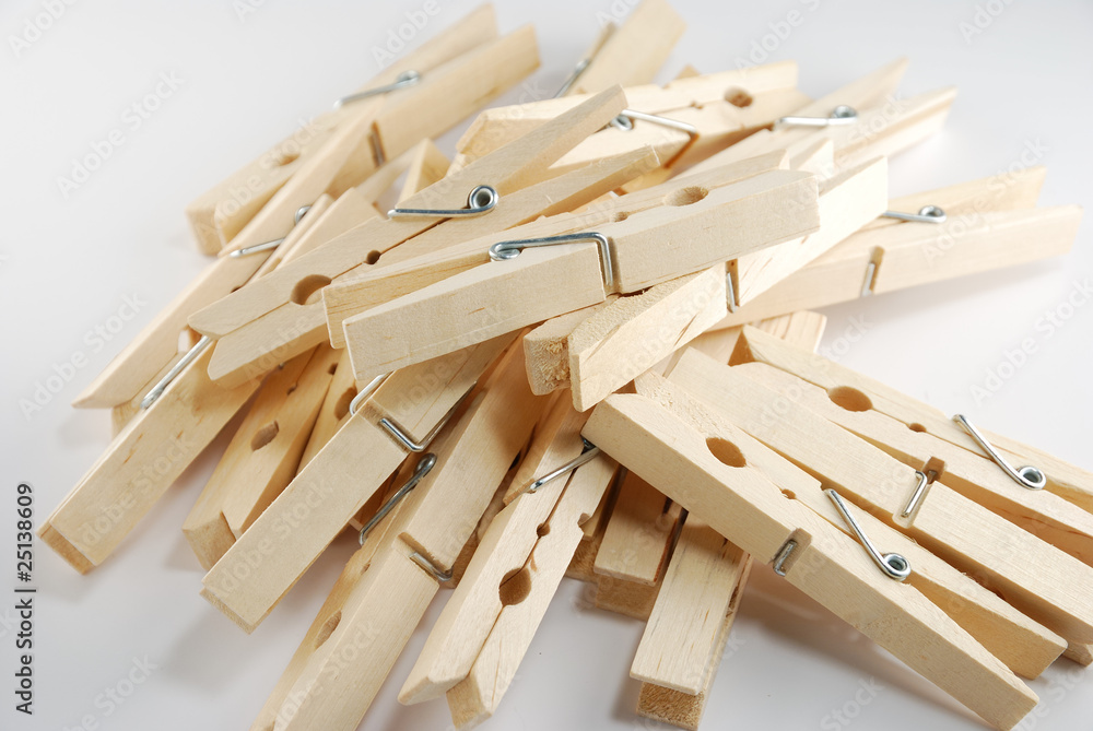 The wooden clothespin pile up on the white background