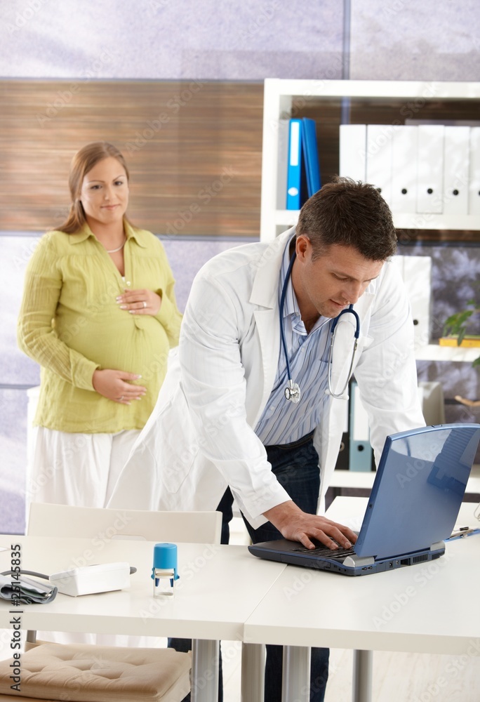 Fototapeta premium Pregnant woman at doctor
