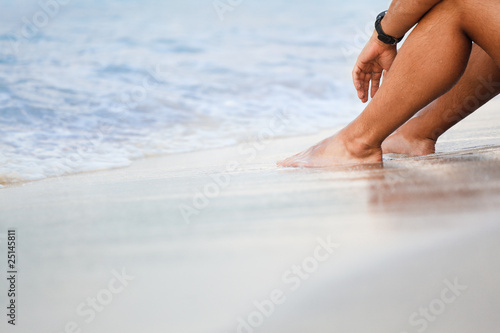 men's legs on sandy beach