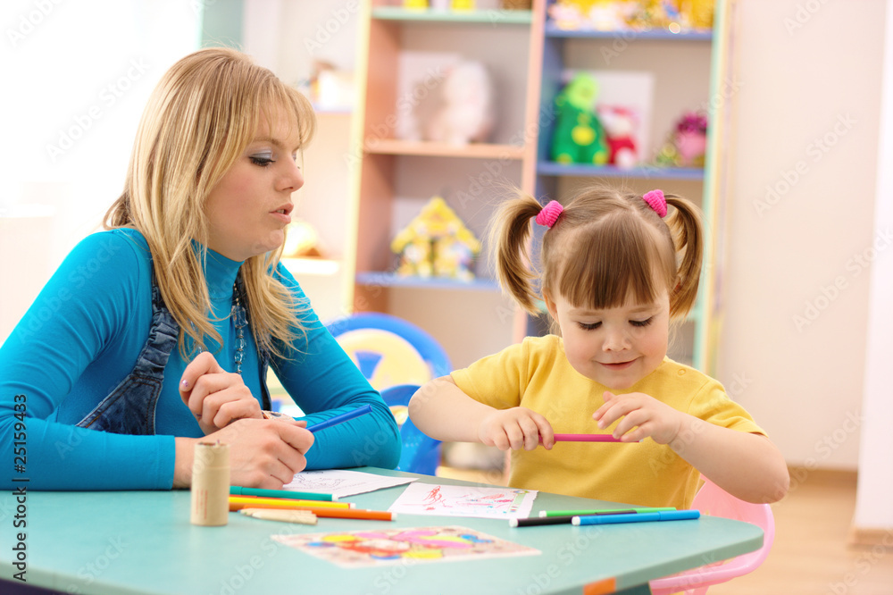Teacher with child in preschool Teacher with child in preschool