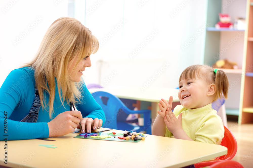 Teacher and little girl play with plasticine Teacher and little girl play with plasticine