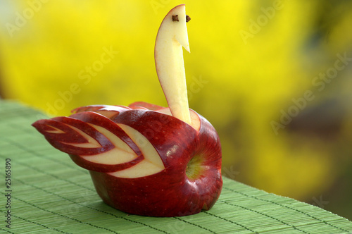 Organic red apple garnished on a summer picnic table
