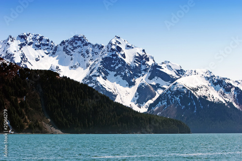 Snowy mountains by water