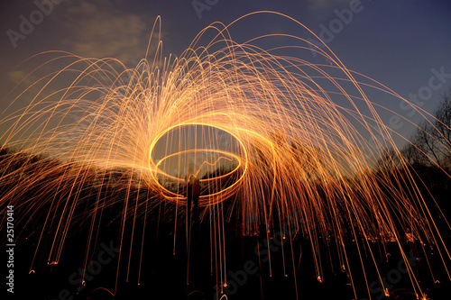 abstract background with orange sparklers flying away at night