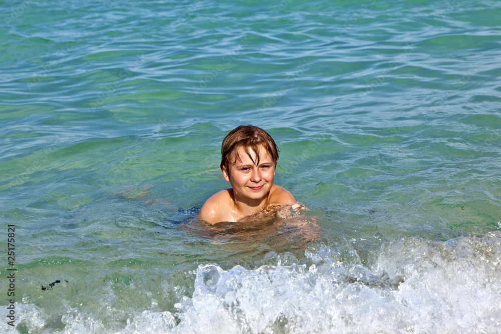 boy enjoys the clear water in the ocean