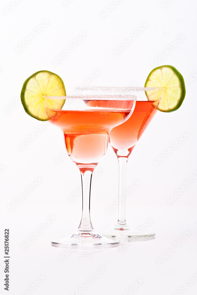 red martini in margarita and martini glasses decorated with lime