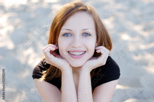 Pretty girl wearing braces smiling cheerfully photo