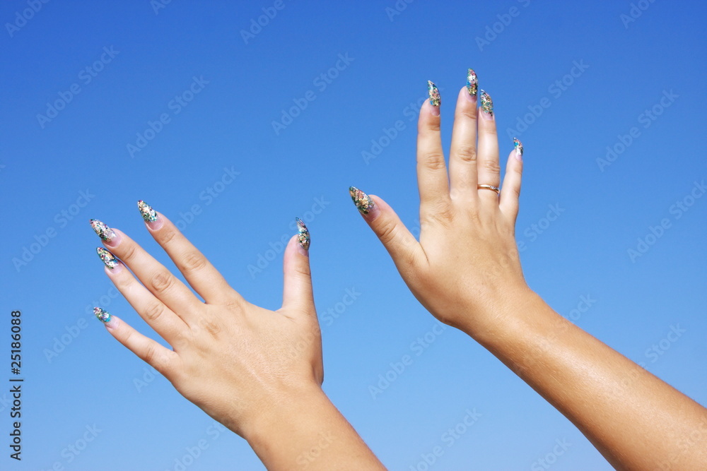 beautiful woman hands on a background blue sky beautiful woman hands on a background blue sky