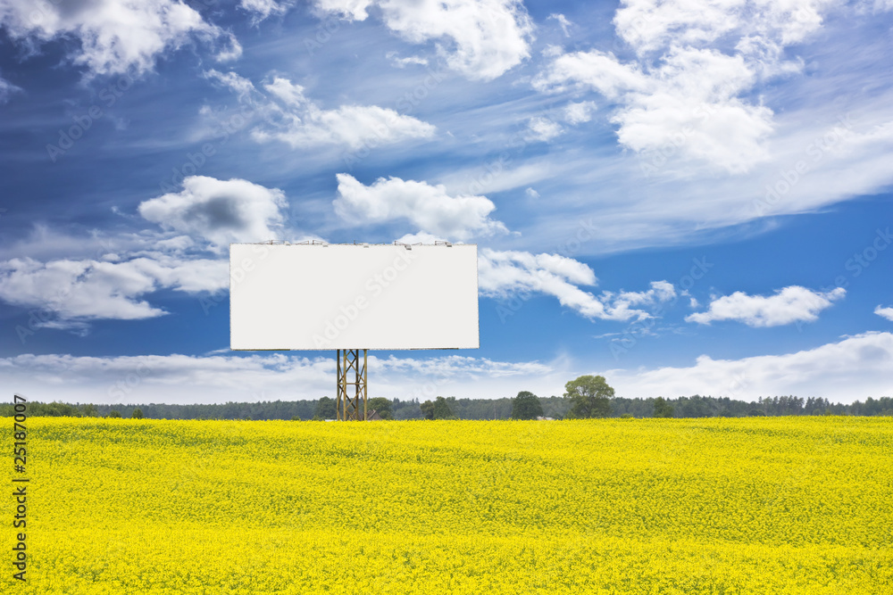 Naklejka premium billboard in rapeseed field