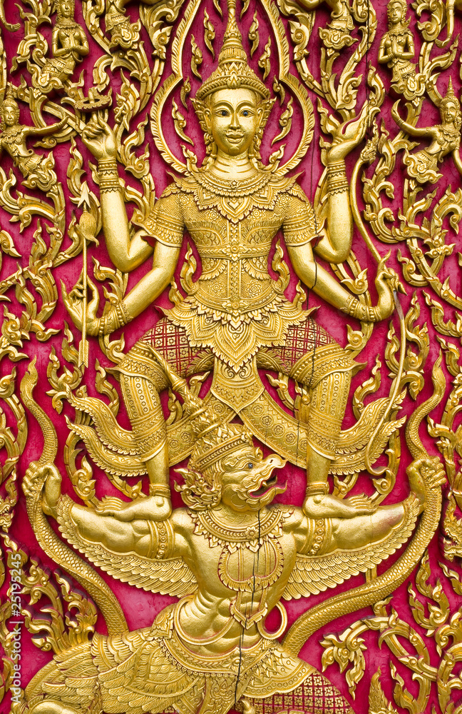 Fototapeta premium Buddha carved gold paint on church door