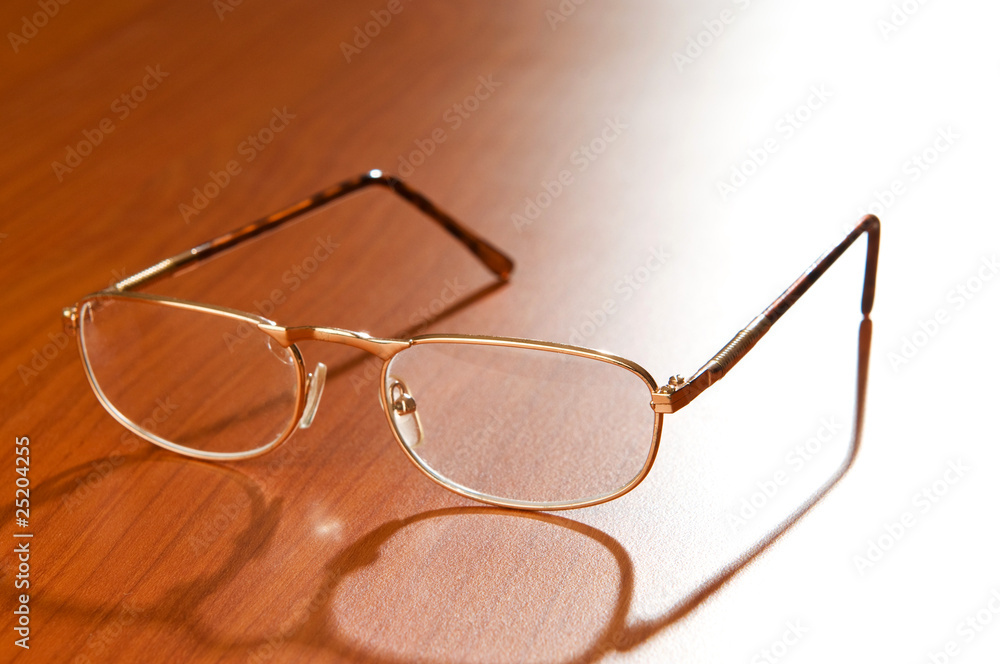 Reading glasses on the wooden background Reading glasses on the wooden background