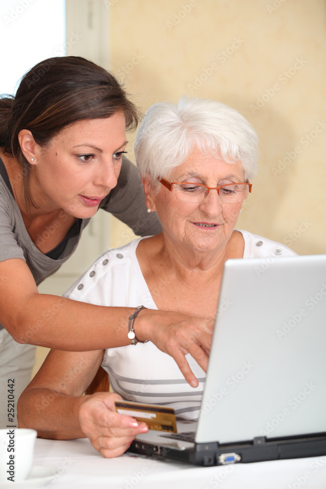 Elderly woman and young woman shopping on internet Elderly woman and young woman shopping on internet