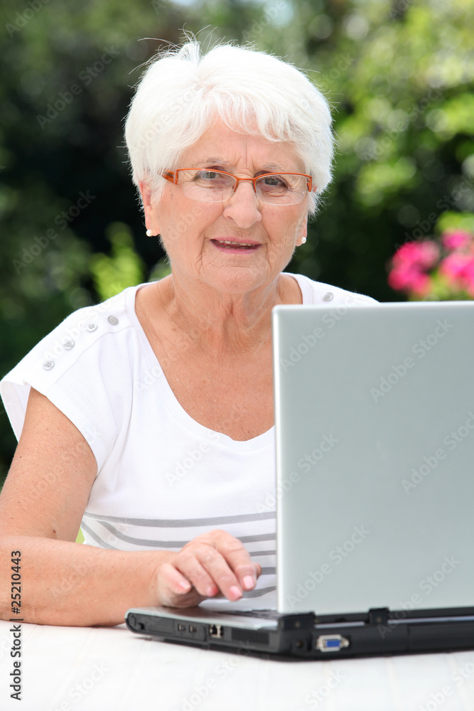 Closeup of elderly woman with laptop computer Closeup of elderly woman with laptop computer