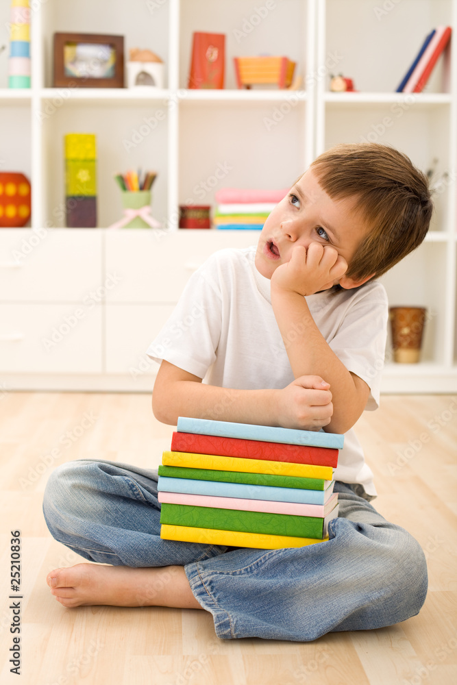 Bored kid with lots of school books Bored kid with lots of school books