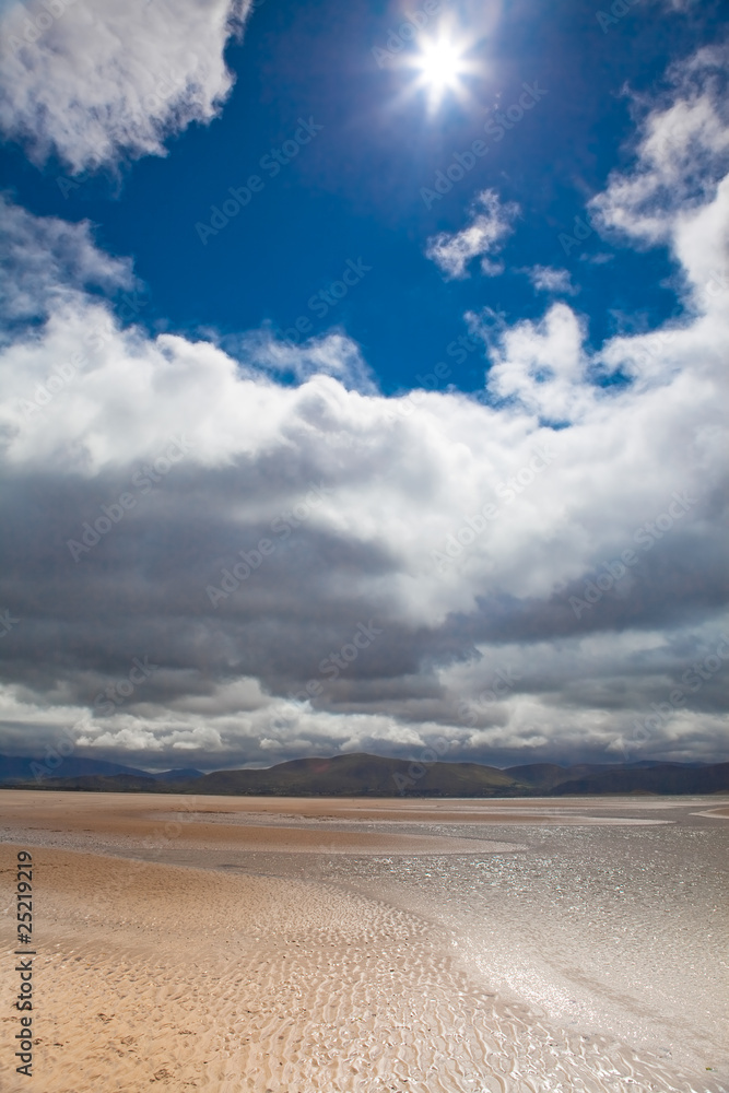 bright sun on sparkling beach white clouds blue sky bright sun on sparkling beach white clouds blue sky