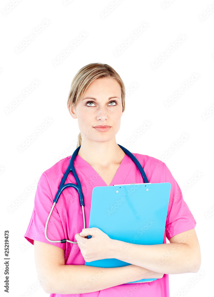 Thoughtful female surgeon holding a clipboard Thoughtful female surgeon holding a clipboard