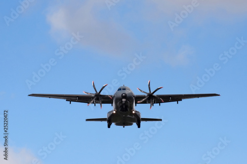 unmarked propeller cargo aircraft on landing approach