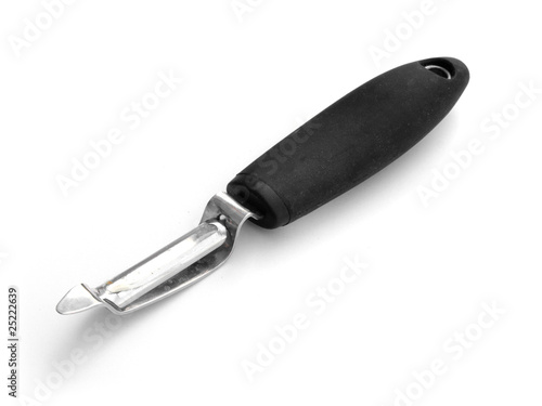 Potato peeler with black handle on white