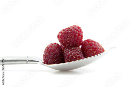 Fresh raspberrie on spoon over white background photo