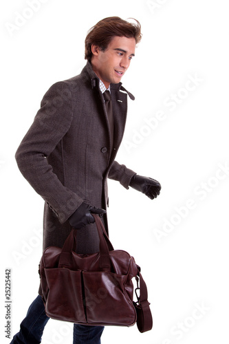 young man with a handbag, hasty, in autumn/winter clothes