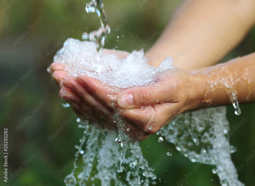 Woman's hands with water splash Woman's hands with water splash