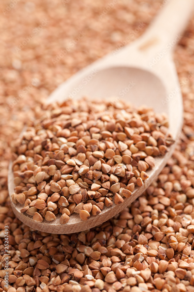 buckwheat in wooden spoon buckwheat in wooden spoon