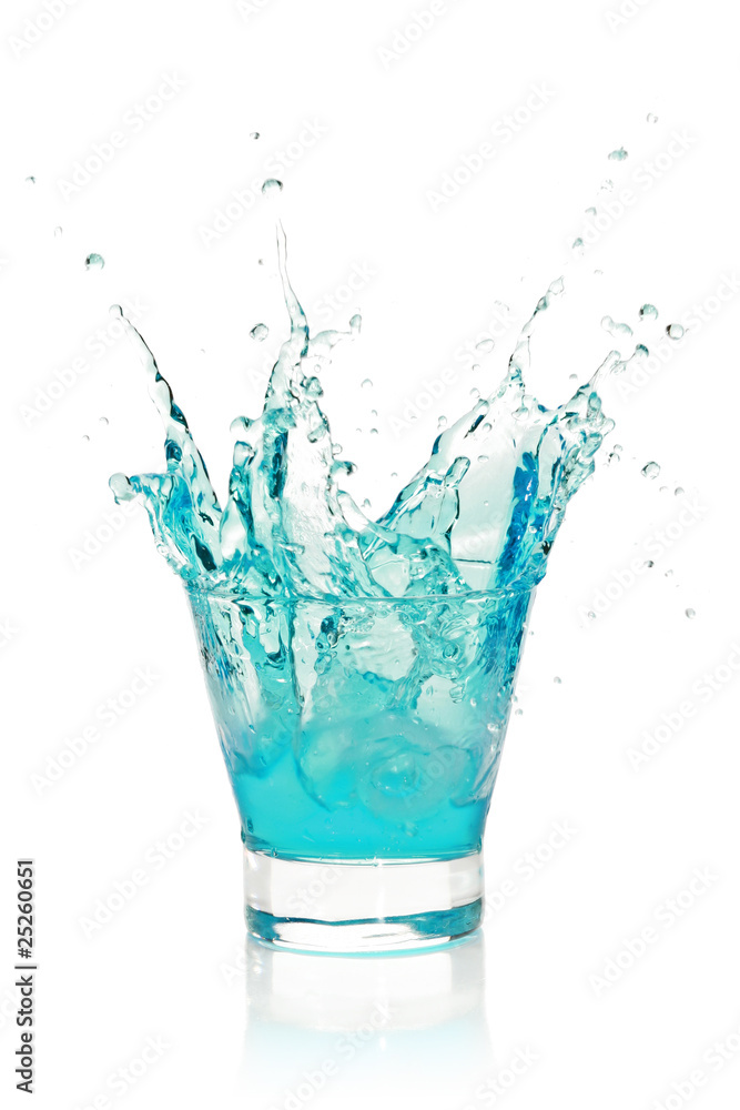 Glass with splashing blue drink Glass with splashing blue drink