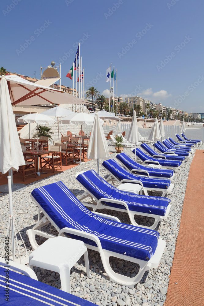 Blue beach lounge chairs on the French Riviera in Nice