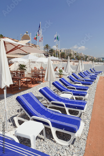 Blue beach lounge chairs on the French Riviera in Nice