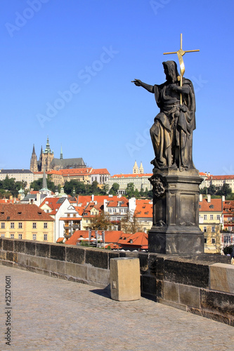 Statue on the Charles Bridge with Prague Castle